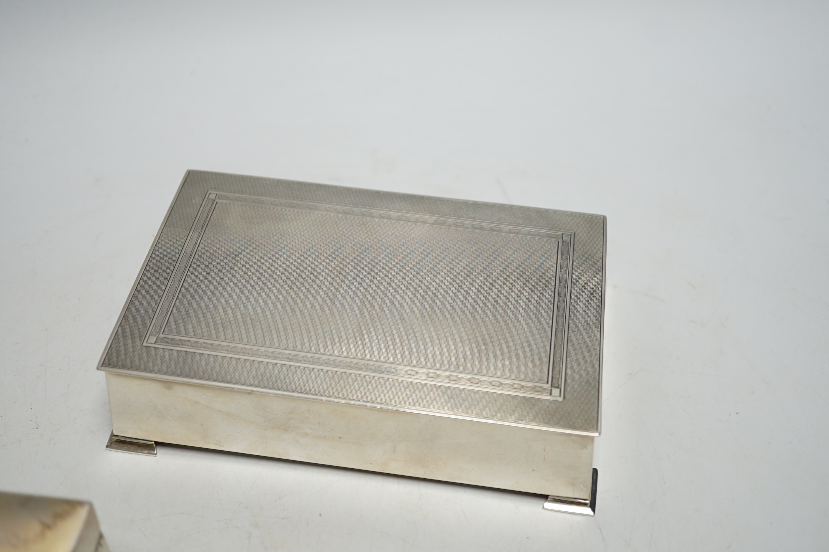 Three assorted silver mounted cigarette boxes including two 1930's, one by Goldsmiths & Silversmiths Co Ltd, largest 15.6cm.